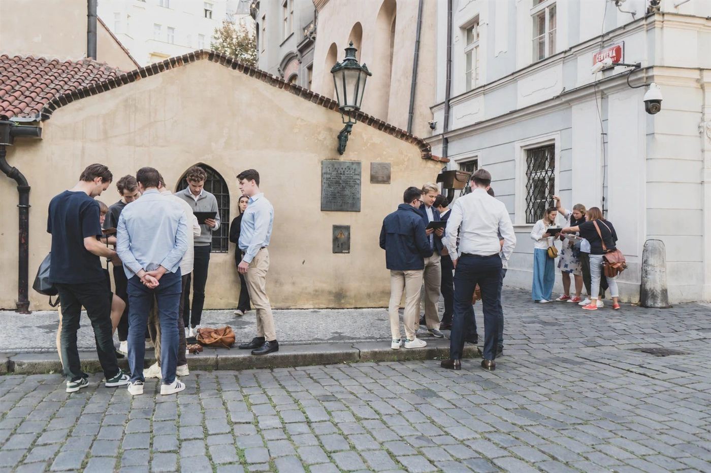 Several teams solving tasks on their tablets in the Old Town streets
