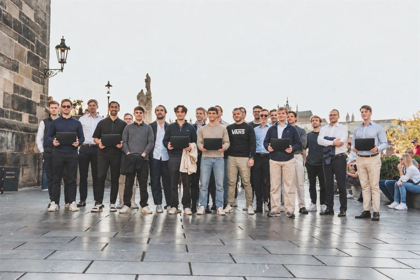 A large company group with their tablets at the Charles Bridge tower