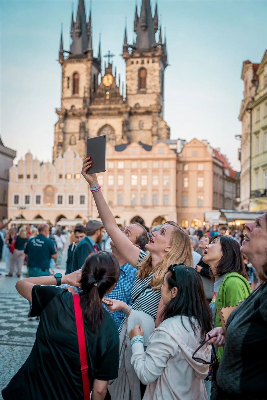 A player raises the tablet in front of the Church of Our Lady before Týn
