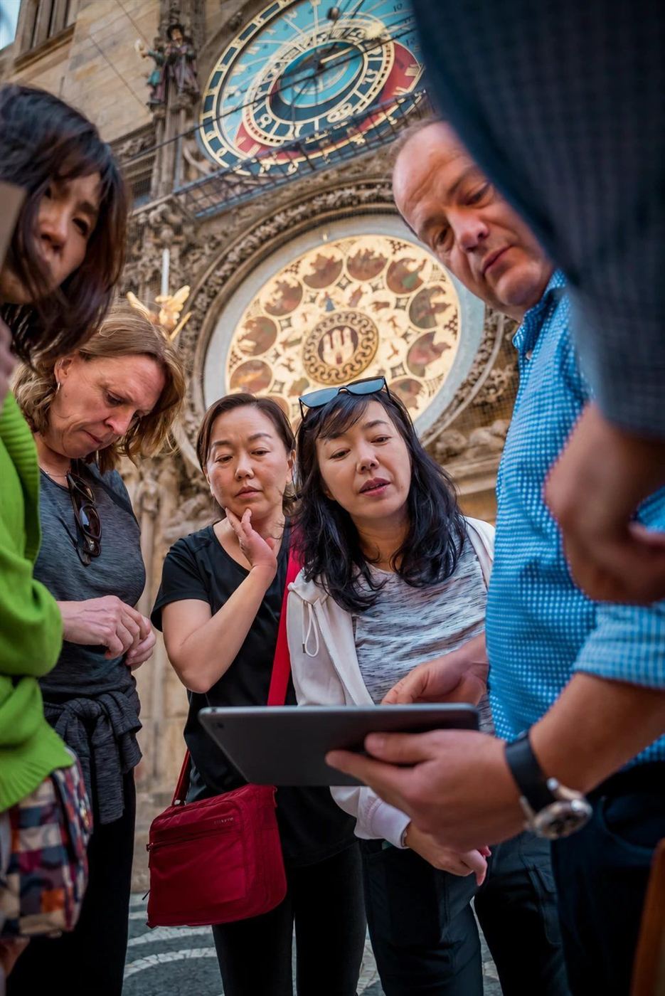 A team solving a puzzle on the tablet beneath the Astronomical Clock