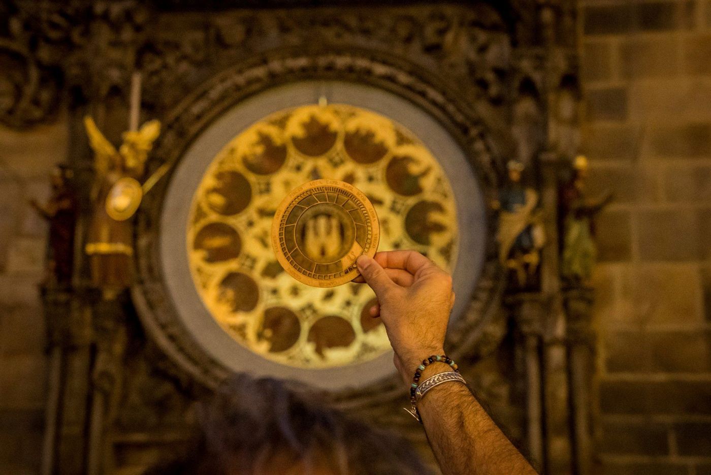 The zodiac wheel held up to the calendar dial of the Astronomical Clock
