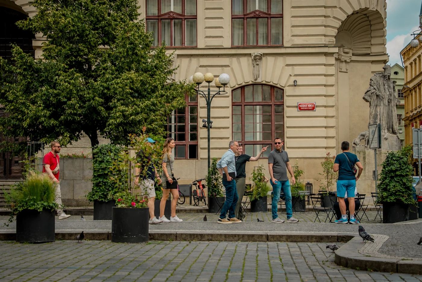 A team on the move across Mariánské Square, past the statue of Rabbi Loew