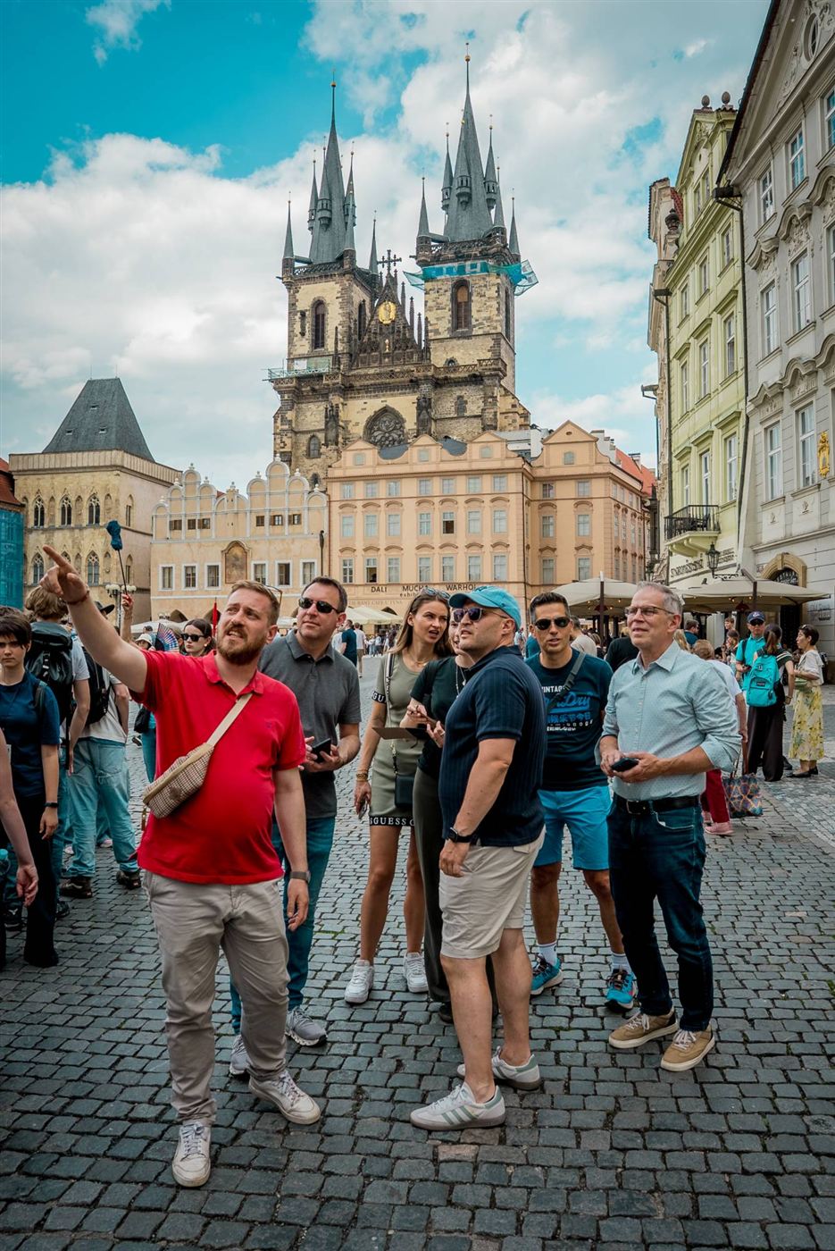 A team on Old Town Square looking up at the Church of Our Lady before Týn
