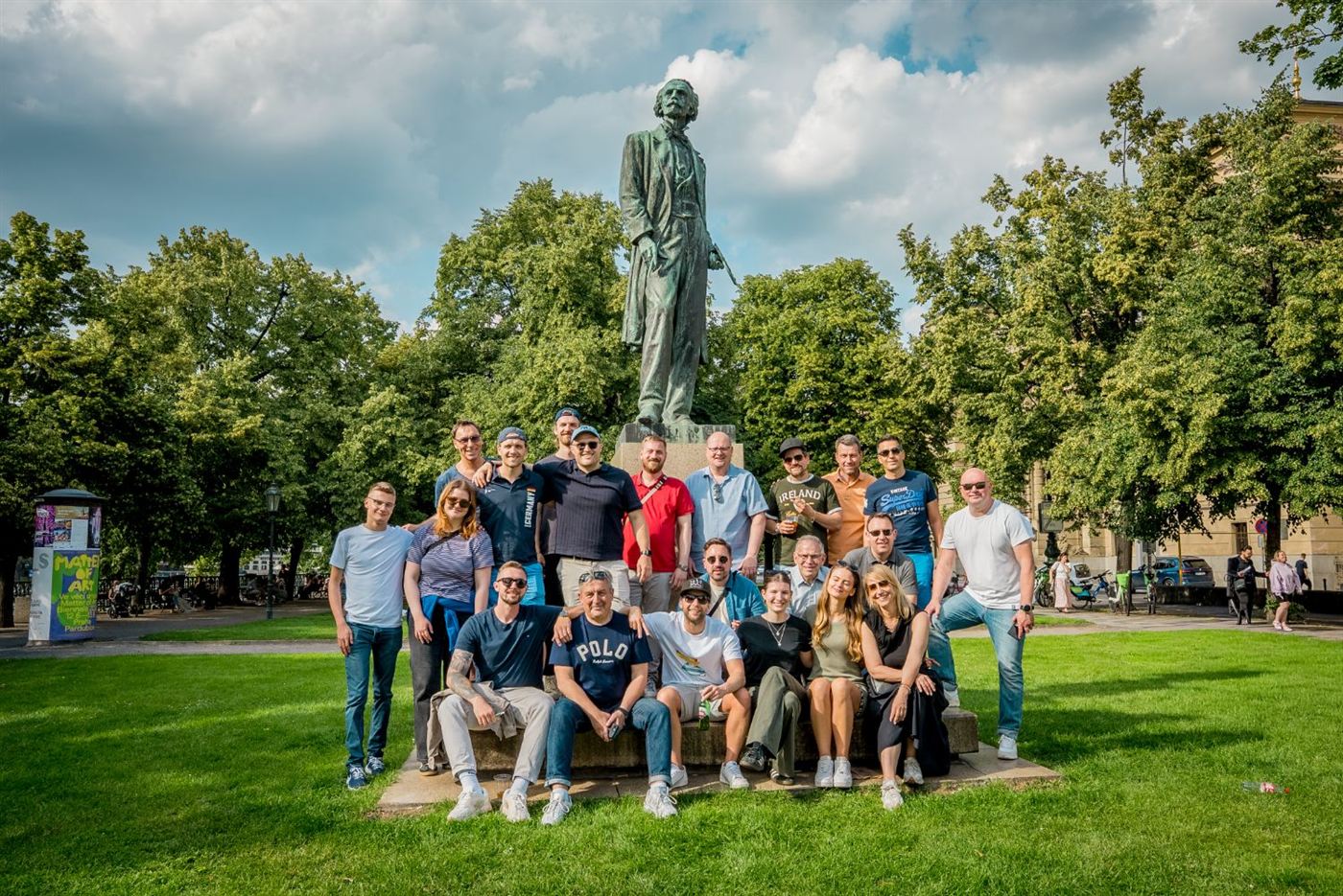 A large team photo by the statue of Antonín Dvořák